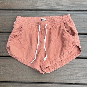 Billabong pale orange linen type shorts. Elastic waist with pockets.